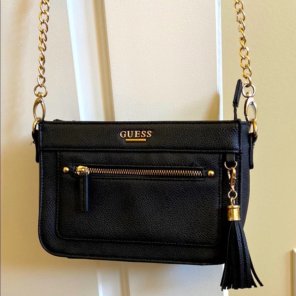 GUESS Black Crossbody Bag with Gold Accents and tassel detail.